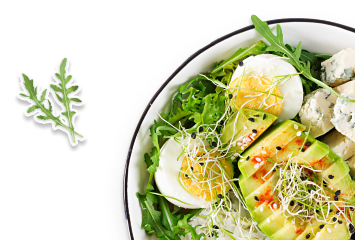 Eggs in a dish with some vegetables.